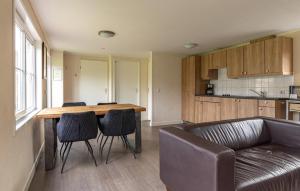 a living room with a table and chairs and a couch at 2 Bedroom Stunning Home In Wagenborgen in Wagenborgen