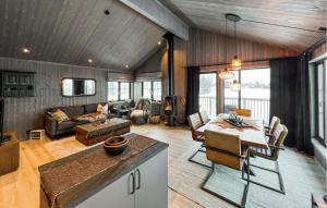 a living room with a table and a dining room at 3 Bedroom Beautiful Apartment In Gol in Gol