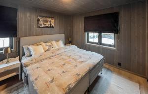 a bedroom with a bed and two windows at 3 Bedroom Beautiful Apartment In Gol in Gol