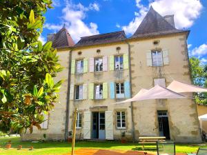 an old building with a tent in front of it at Domaine Le Berdoy in Montesquiou