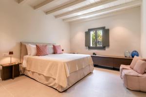 a large bedroom with a bed and a chair at Simple House Mykonos Sunset in Mýkonos City