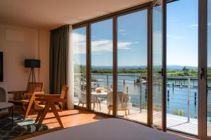 a bedroom with a view of a balcony at Hotiday Grado Marina in Grado