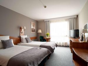 Posteľ alebo postele v izbe v ubytovaní Mercure Cieszyn