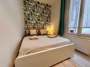 a small bedroom with a bed with two towels on it at Rue piétonne - 4 pers - Proche place du marche in Fontainebleau