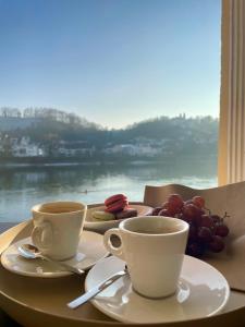two cups of coffee on a table with a view at Schloß Ort in Passau +161 photos