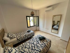 a living room with two beds and a mirror at El oasis Monaco - 3 chambres in Fuente-Álamo de Murcia +13 photos
