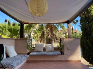 a porch with two pillows and a tent at El oasis Monaco - 3 chambres in Fuente-Álamo de Murcia