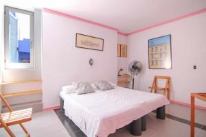 a bedroom with a bed and a desk and two windows at Apartment with beautiful views - Muralla0218 in Calpe