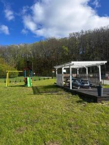 a park with a pavilion and a playground at Chatki przy Marinie in Wapnica +22 photos