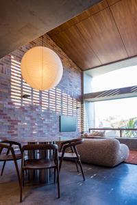 a living room with a table and chairs and a tv at Camperdown - Luxury Architectural Escape in Sydney
