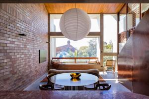 a living room with a table and a couch at Camperdown - Luxury Architectural Escape in Sydney