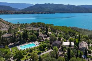 an aerial view of a house with a lake at Centro de Vacaciones Morillo de Tou - Ainsa in Aínsa