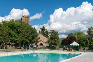 a swimming pool with a building in the background at Centro de Vacaciones Morillo de Tou - Ainsa in Aínsa