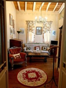 a living room with a couch and a chair at La Ferme de Jeanne in Saint-Girons