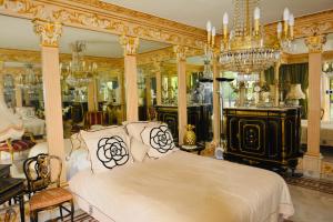 a bedroom with a bed and a chandelier at NEW ÉTOILE Arc de Triomphe renovated March 24 in Paris