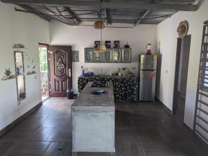 a kitchen with a counter and a refrigerator at Blue Whale in Pedasí Town