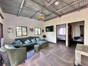 a living room with a couch and a table at Blue Whale in Pedasí Town