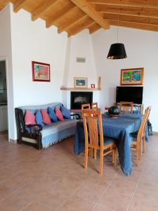 a living room with a couch and a table at Casa Atlântico in Odeceixe