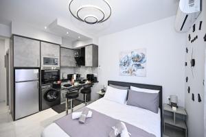 a small bedroom with a bed and a kitchen at Sea & Joy Studio in Ialysos