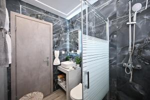 a bathroom with a sink and a toilet and a shower at Sea & Joy Studio in Ialyssos