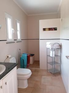 a bathroom with a toilet and a sink at Casa Atlântico in Odeceixe +63 photos