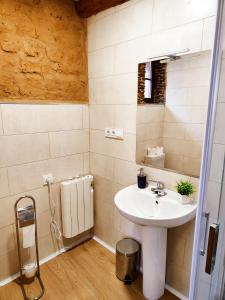 a bathroom with a sink and a mirror at Hostal Restaurante LA SENDA in Camponaraya +29 photos
