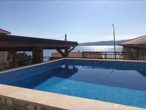 a swimming pool with a view of the water at Vuke Apartments in Senj