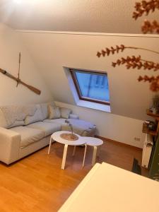a living room with a couch and a table at Seute Deern- Görtz in Fehmarn