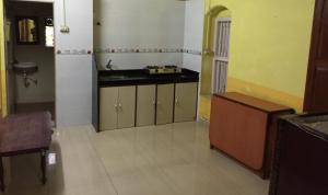 an empty kitchen with a sink and a counter at Lilly Vacation Homes - Alibaug in Kīhīm