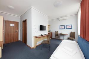 TV a/nebo společenská místnost v ubytování Hotel Nikolas
