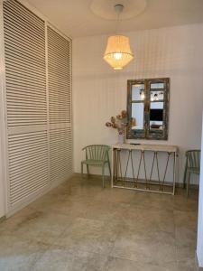 a room with two chairs and a table and a mirror at Casa Ambra in Specchiolla +8 photos