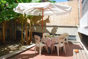 a table and chairs under an umbrella on a patio at A Casa di Pe' Casa Vacanze in Rome