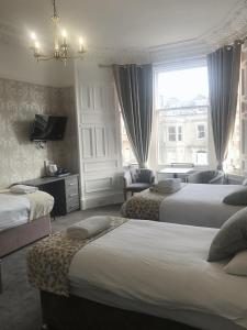 una camera d'albergo con due letti e una finestra di Arrandale Guest House a Edimburgo
