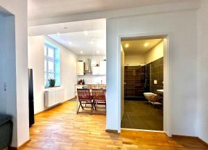 a living room and a kitchen with a table and chairs at Castle View Apartment 3 in Weilburg
