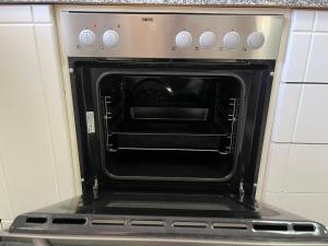 an oven with its door open in a kitchen at Vacation Ηouse in Nea Plagia of Halkidiki, Greece in Nea Plagia
