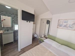 a bedroom with a bed and a sink and a mirror at Scauri Rooms B&B in Minturno