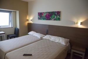 Postel nebo postele na pokoji v ubytování Hotel Izelai