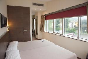 Postel nebo postele na pokoji v ubytování Hotel Izelai