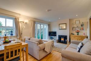 a living room filled with furniture and a fireplace at Rosemary's - coastal cottage Seaton in Seaton