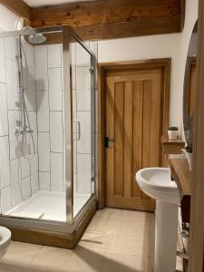 a bathroom with a shower and a toilet and a sink at Fir Lodge in King's Lynn +221 photos