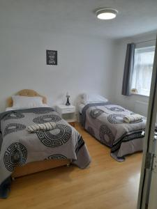 a bedroom with two beds and a window at Bridgewoods in Chatham