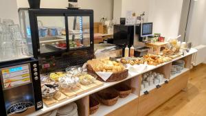 a bakery counter with bread and pastries on display at Self-service Hotel Ostaš Praha in Prague
