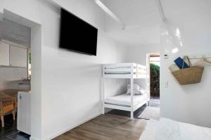 a white room with a tv on a wall at Holiday Apartment At Solgaarden 1 In Årsdale in Svaneke