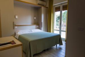 Postel nebo postele na pokoji v ubytování Hotel Mirella
