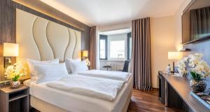 Postel nebo postele na pokoji v ubytování PLAZA Hotel Buchhorner Hof