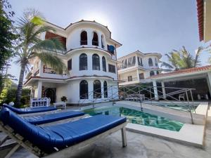 a large house with a swimming pool in front of it at J and R Villa, Watamu in Watamu