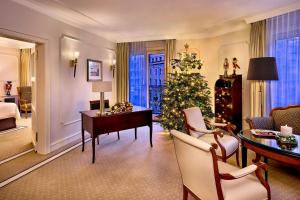 a living room with a christmas tree and a desk at The Westin Grand Berlin in Berlin