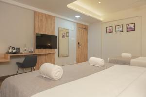 Hotel Shoolin Comforts客房内的一张或多张床位