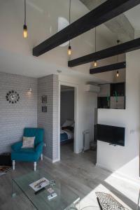 a living room with a blue couch and a bedroom at Apartment Savamala Art in Belgrade