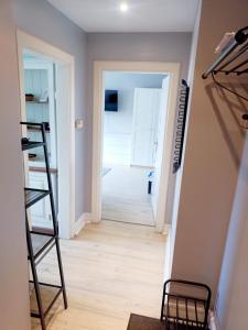 a room with a staircase and a room with a hallway at Brick Lane Apartment in Gdańsk